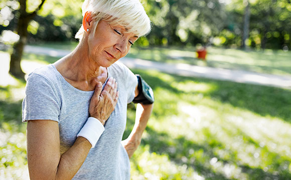 older woman having chest pain after workout