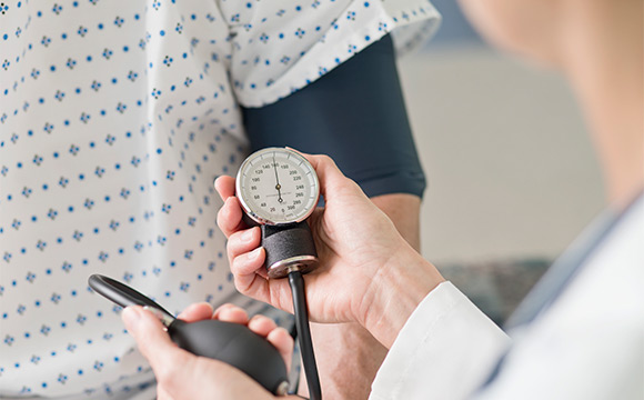 doctor taking patients blood pressure
