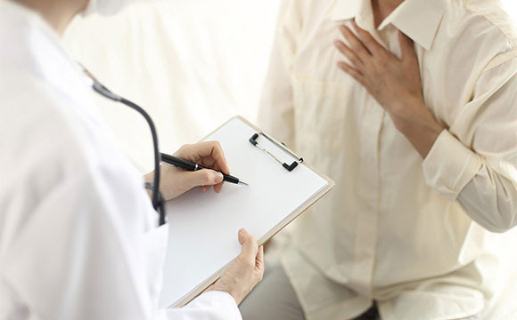 doctor speaking with patient with chest pain