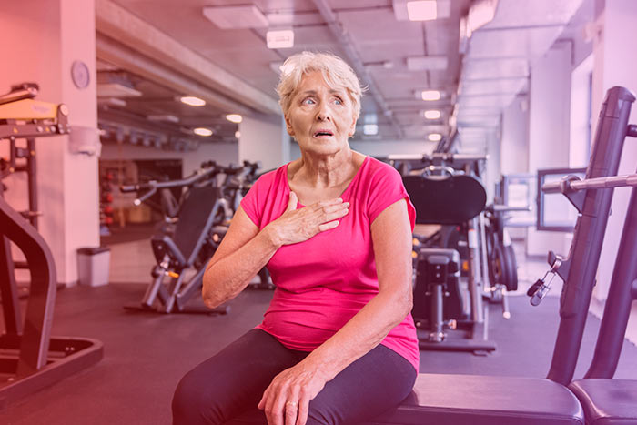 Exhausted elder woman at gym